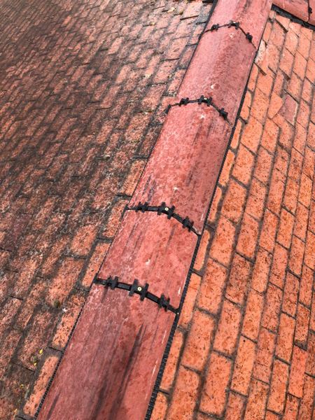 Close view of the clipped ridge joints and the edge strip against the tiles