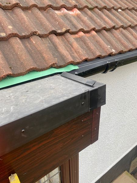 Finished bay roof corner with black edge trim and moulded corner piece