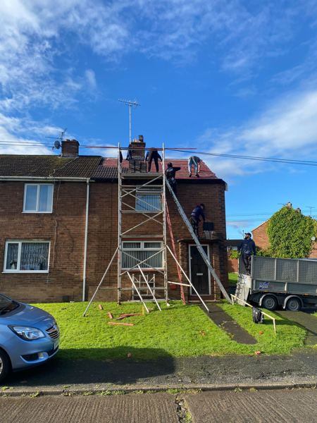 Stripping the old red tiles from the front of the Wrexham semi