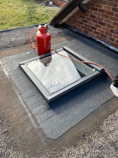 Finished skylight on the flat roof with new felt around it and gas bottle