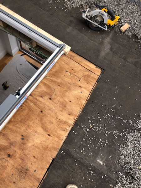 Plywood deck boarded around the opening, skylight frame and saw alongside