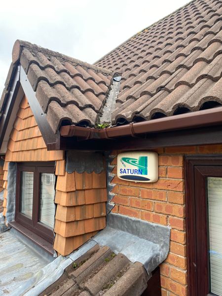 Side of the dormer with brown UPVC fascia and gutter, tile hanging and lead