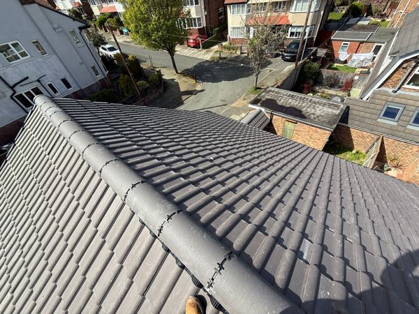 Dry-fixed ridge and hip over the finished grey tiles