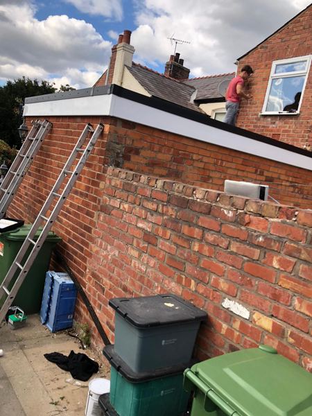 Finished fascias along the side wall, with ladders still in place