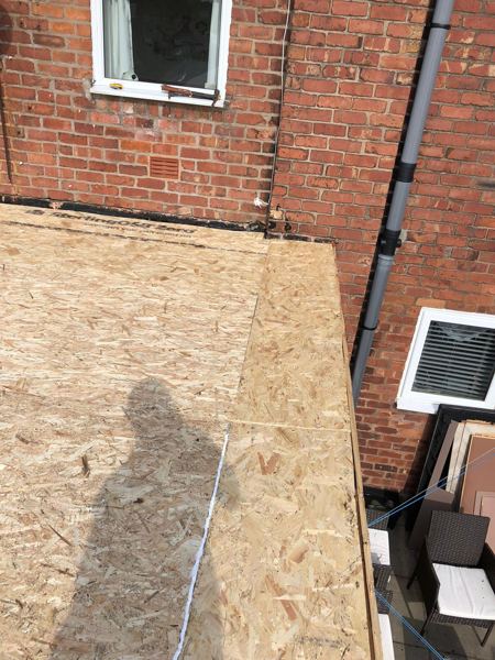 New OSB deck boards laid tight to the house wall