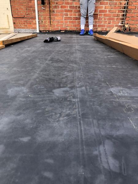 Rubber membrane laid across the roof up to the house wall