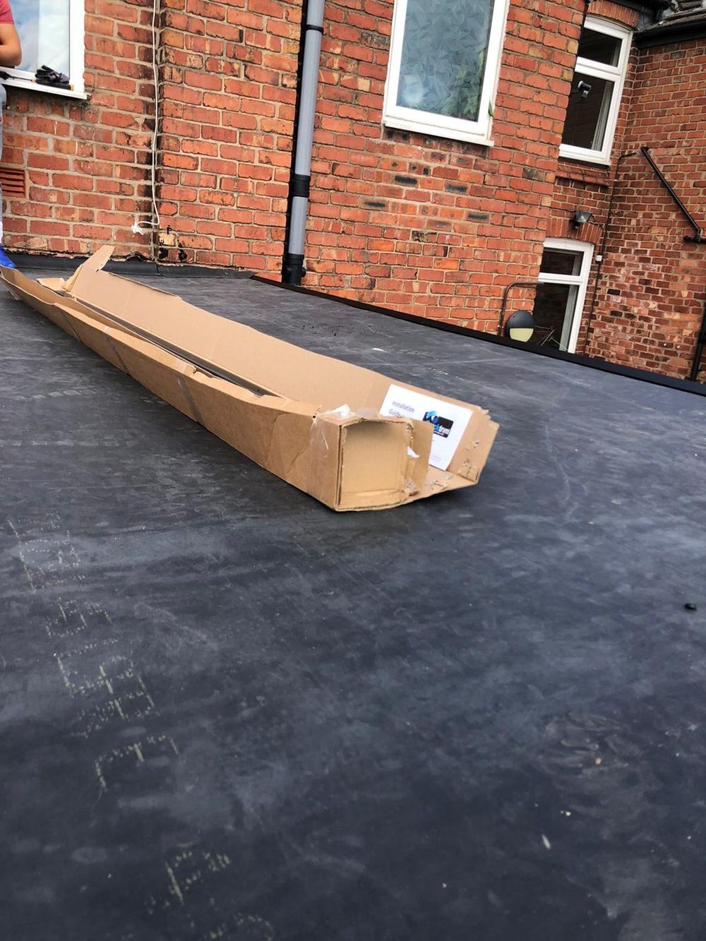 The EPDM sheet rolled out flat across the deck and left to relax before it is bonded