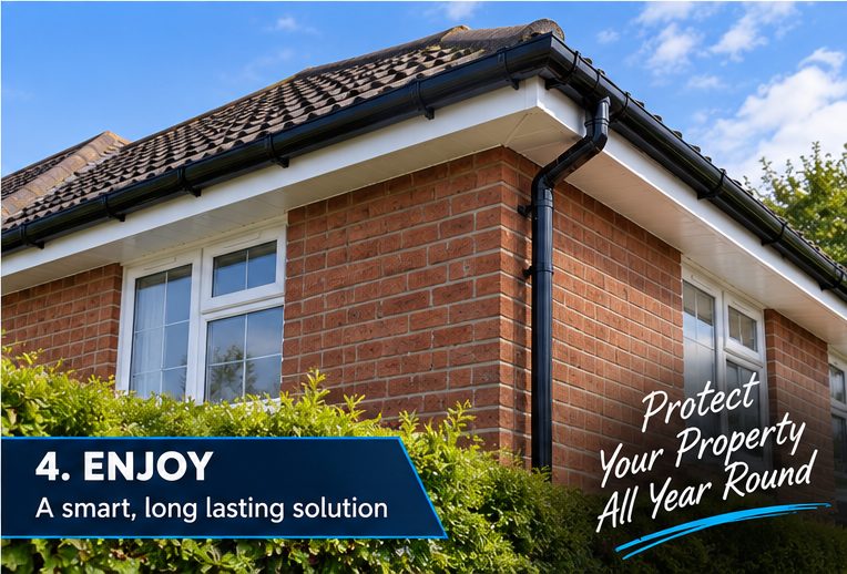A tiled bungalow roof corner finished in white UPVC fascia and soffit with black guttering and a downpipe